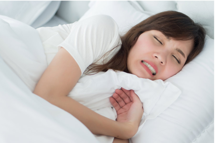 sleeping woman grinds her teeth